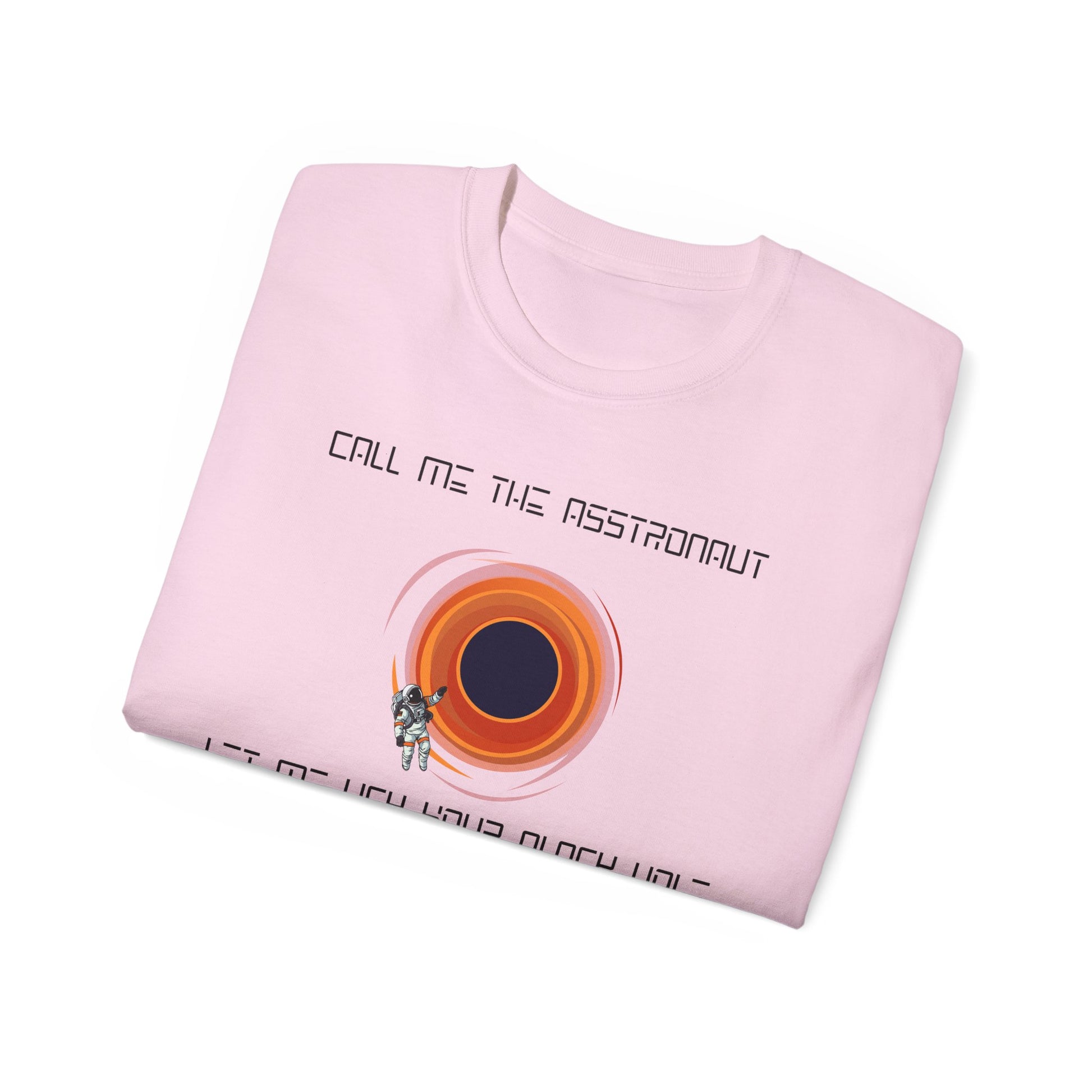 Folded Asstronaut T-shirt with partial black hole design visible, pink colour version
