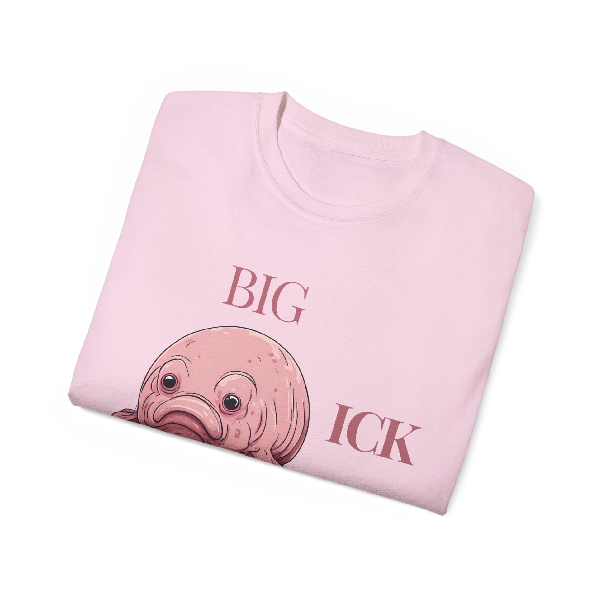Folded Big Ick Energy T-shirt with partial view of creature design, pink colour version