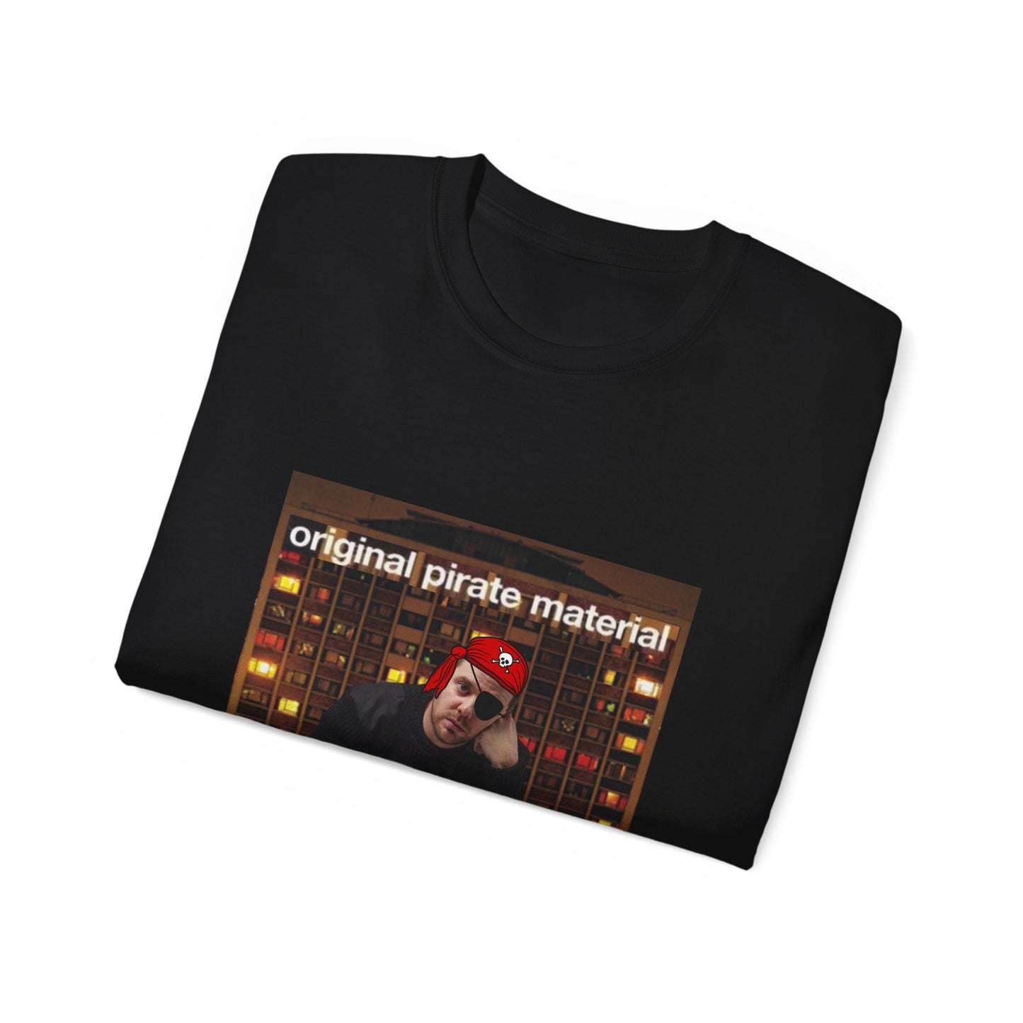 Folded Original Pirate Material T-shirt partially showing pirate Mike Skinner and tower block design black colour version