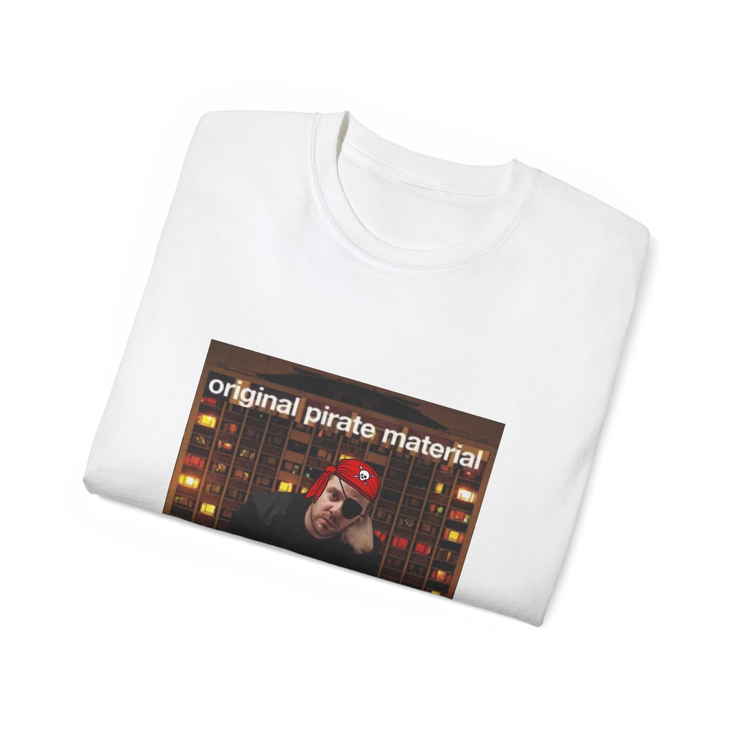 Folded Original Pirate Material T-shirt partially showing pirate Mike Skinner and tower block design