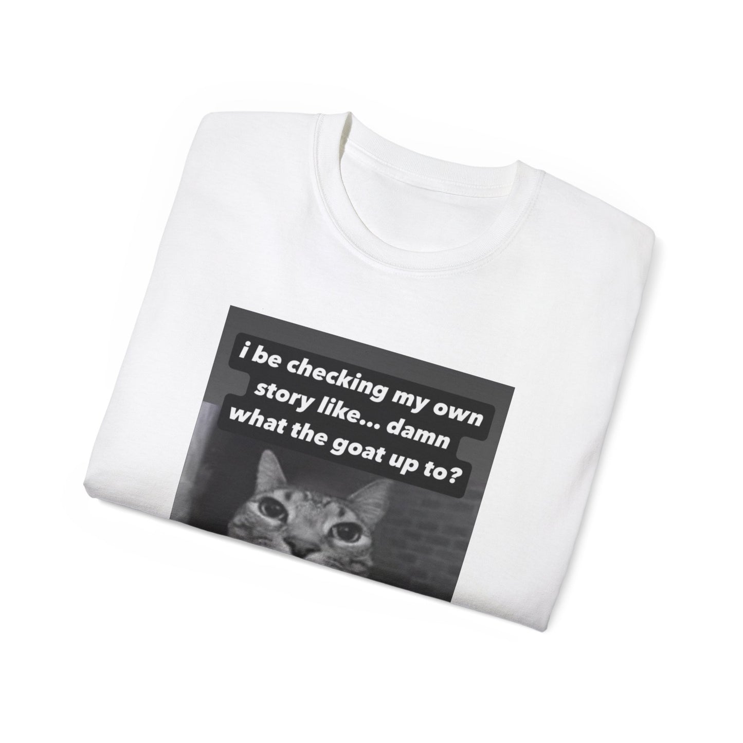 Folded What the Goat Up To T-shirt partially showing cat illustration and caption on fabric white colour version
