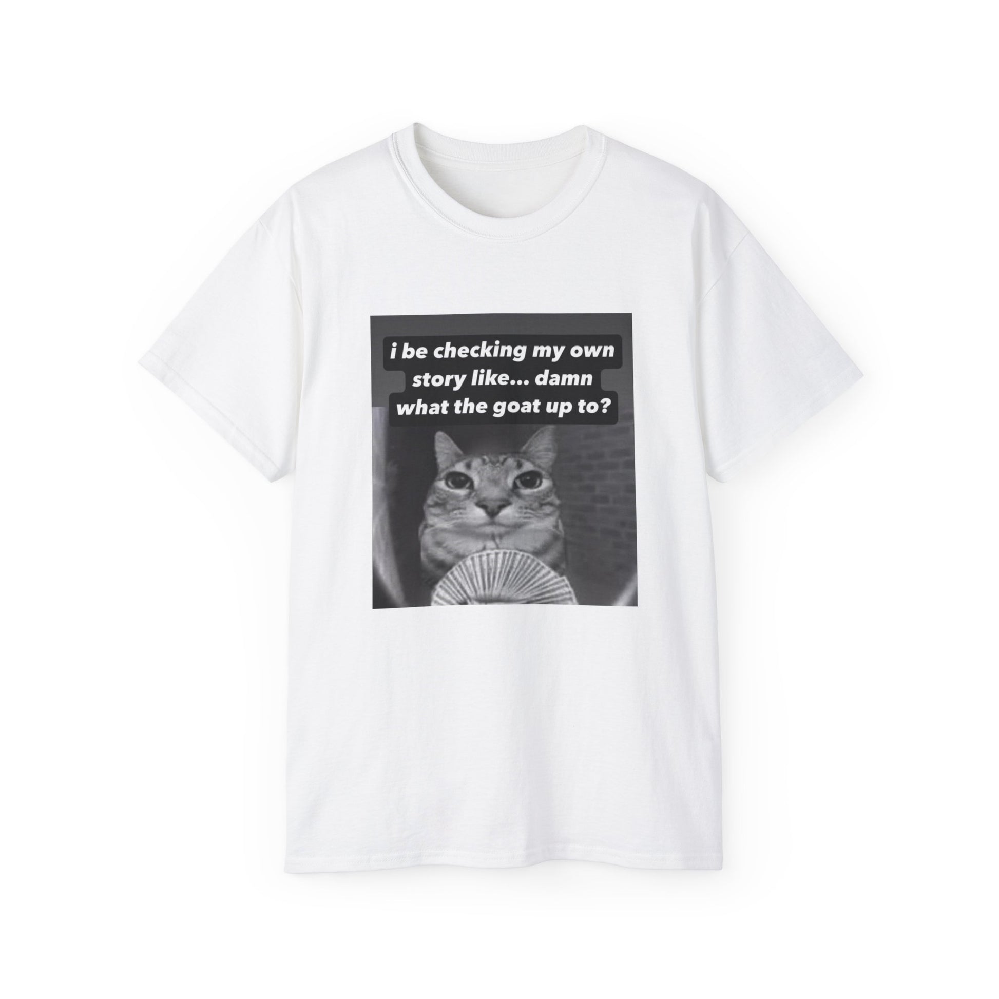Front view of What the Goat Up To T-shirt featuring wide-eyed cat staring forward with caption “What the goat up to” white colour version