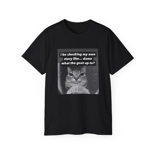 Front view of What the Goat Up To T-shirt featuring wide-eyed cat staring forward with caption “What the goat up to”